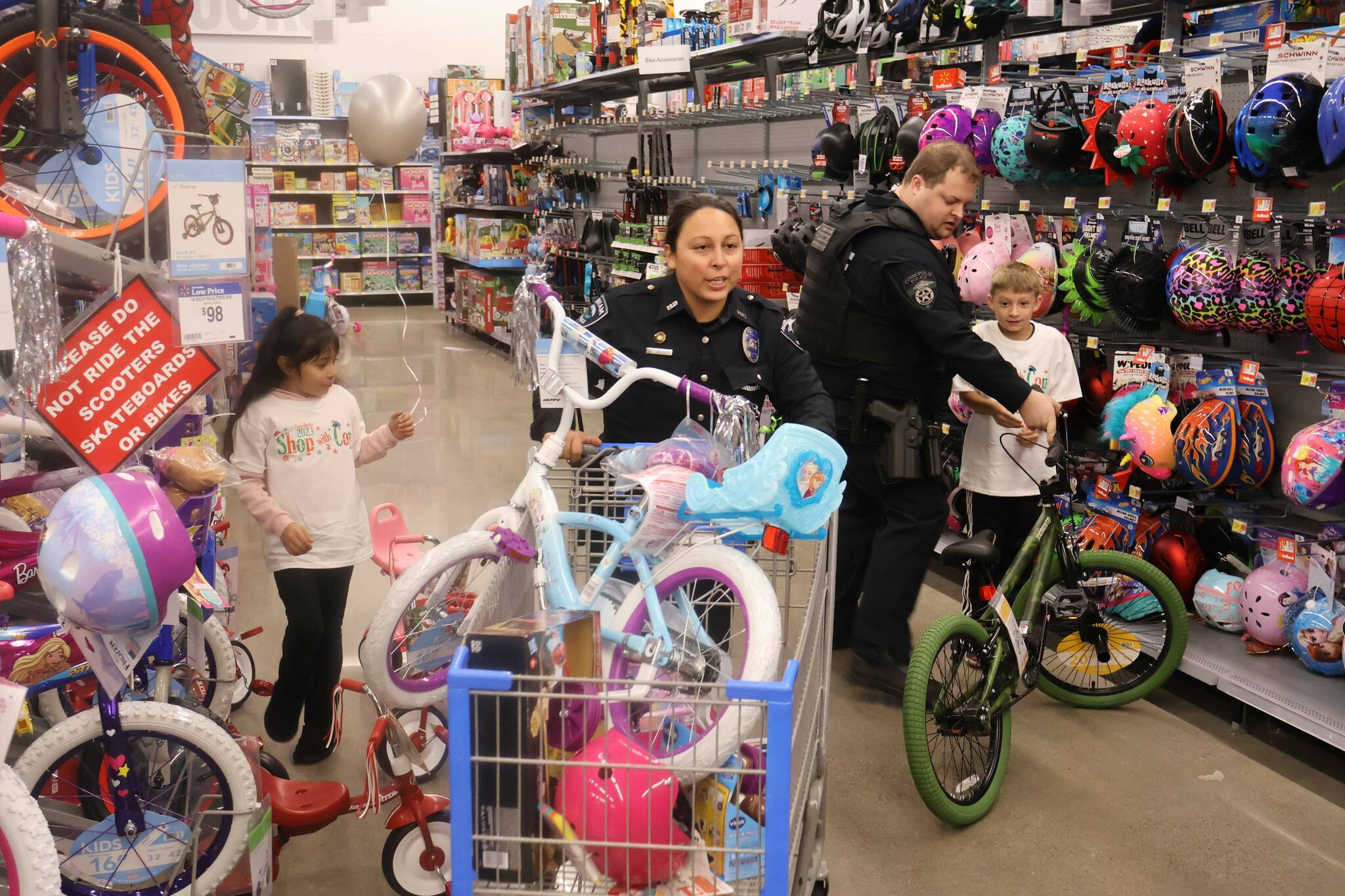 Law enforcement personnel and children buddied up for the annual Shop with a Cop event on Saturday. (Michael S. Lockett / The Daily World)