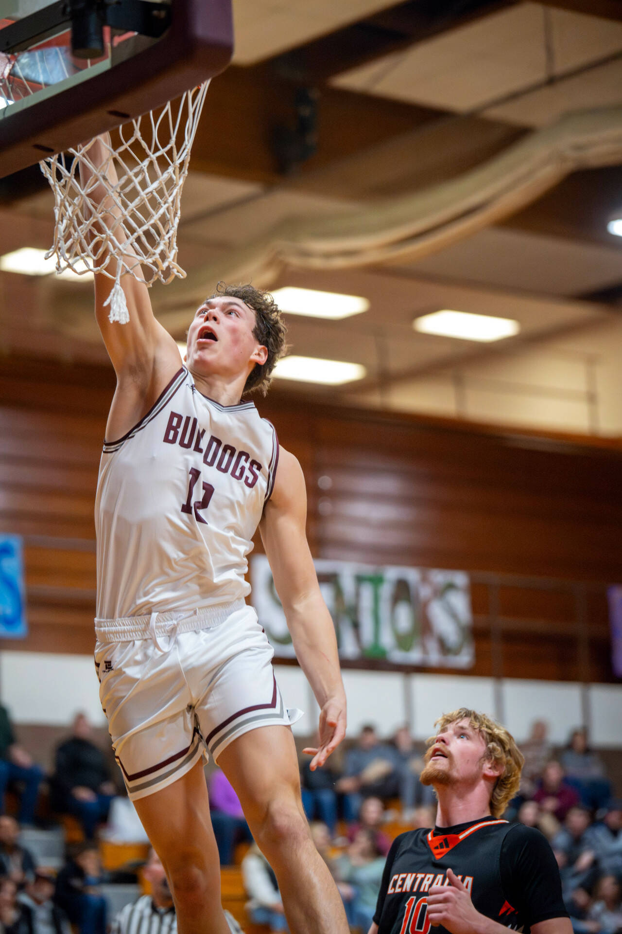 PHOTO BY FOREST WORGUM Montesano senior foward Gabe Bodwell (12) dunks for two of his 10 points in a 69-43 victory over Centralia on Tuesday in Montesano.