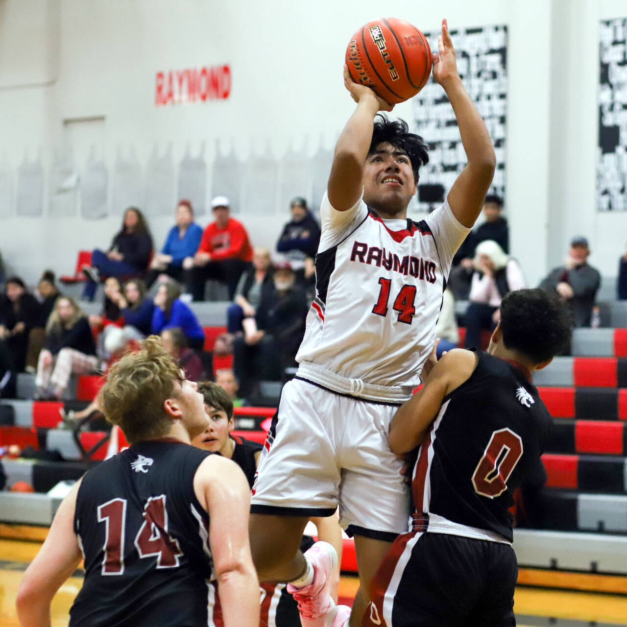 PHOTO BY LARRY BALE Raymond’s Christopher Quintana (14) scores two of his team-high 21 points during a 52-42 win over Ocosta on Wednesday in Raymond.