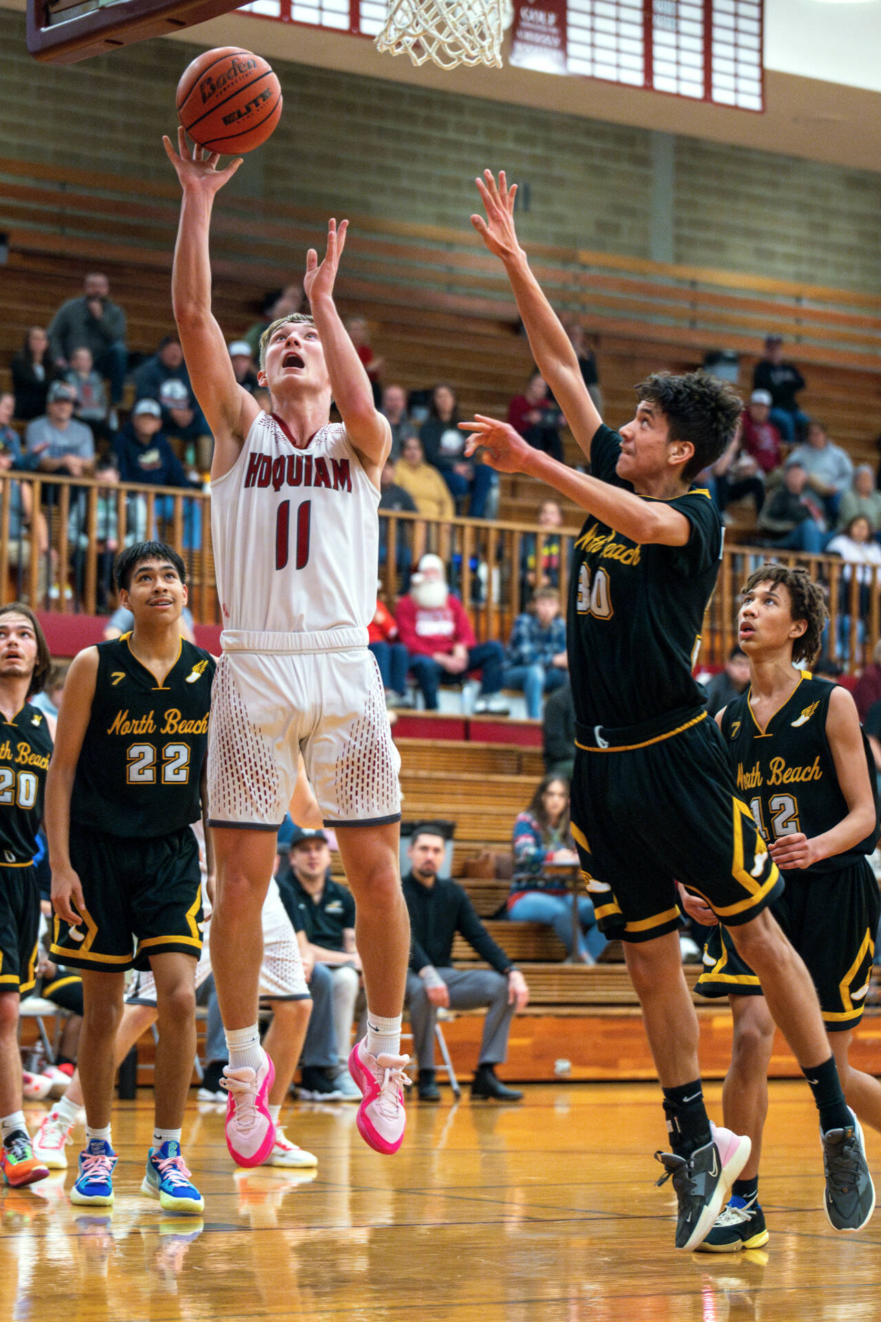 PHOTO BY FOREST WORGUM Hoquiam senior Zander Jump (11) puts up a shot against North Beach’s Jeremiah Eastman during the Grizzlies’ 71-31 victory on Thursday at Hoquiam Square Garden.