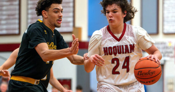 PHOTO BY FOREST WORGUM Hoquiam guard Lincoln Niemi (24) dribbles against North Beach’s Tyrell Hovland during the Grizzlies’ 71-31 victory on Thursday at Hoquiam Square Garden.