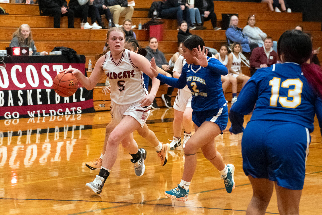 PHOTO BY VAN ADAM DAVIS Ocosta sophomore Anna Davis (5) reads the floor while defended by Chief Leschi’s Rosalina Santos-Banuelos (2) during a 53-47 win on Thursday in Westport.