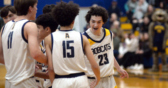 RYAN SPARKS | THE DAILY WORLD Aberdeen guard Jhacob Quezada (23) celebrates with his teammates during the Bobcats’ 55-49 overtime win on Monday in Aberdeen.