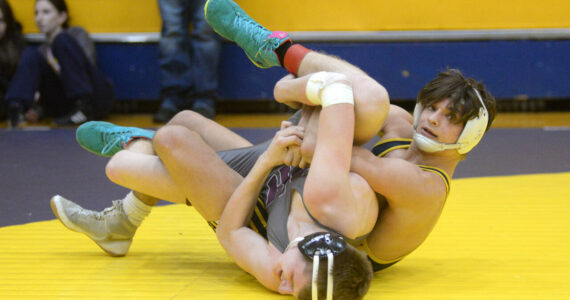 RYAN SPARKS / THE DAILY WORLD Aberdeen’s Aidan Watkins, right, controls the legs of Willapa Harbor’s Connor Reyes during a 157-pound match at the Grays Harbor Championship meet on Saturday at Aberdeen High School.
