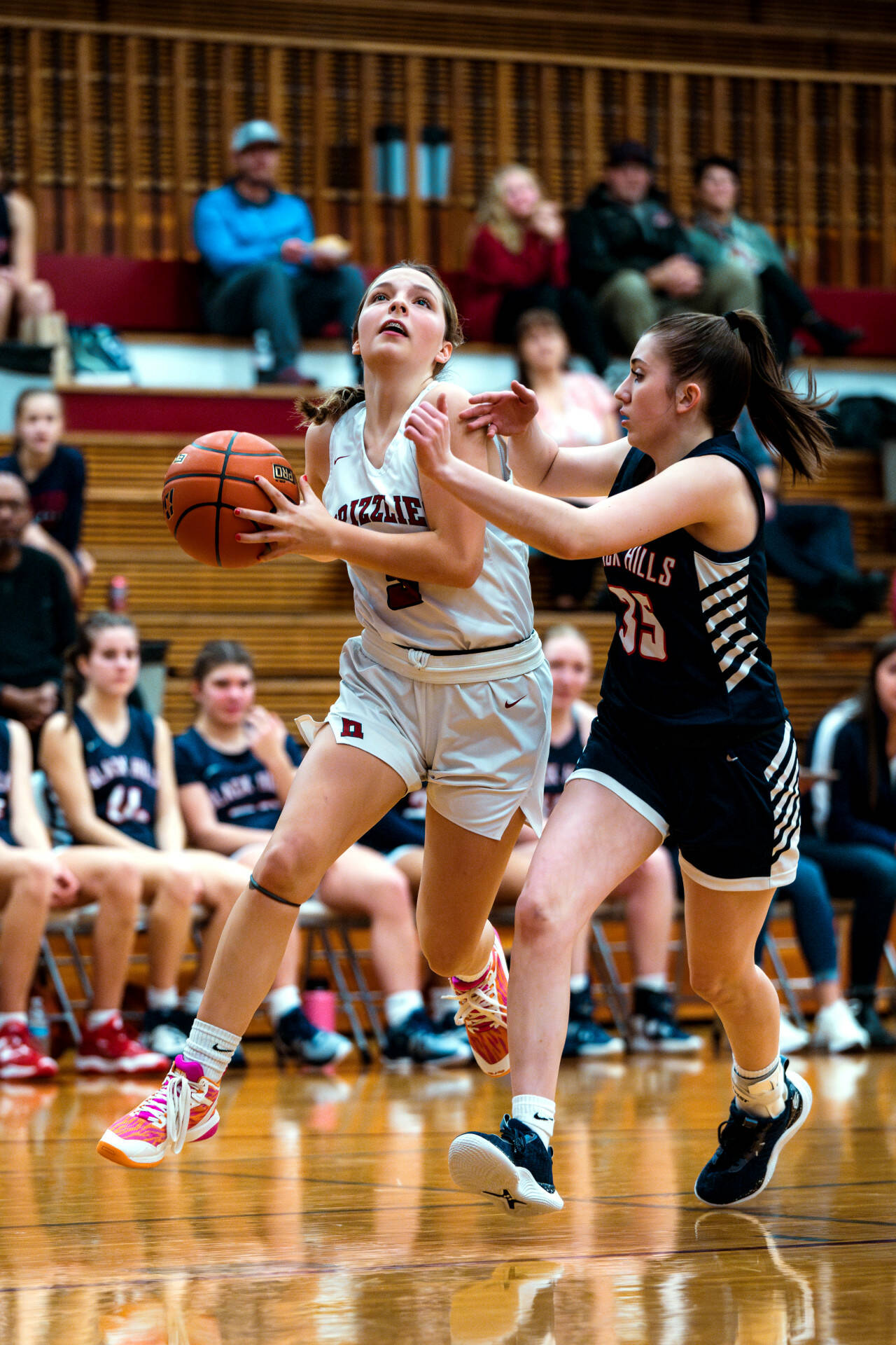 PHOTO BY FOREST WORGUM Hoquiam’s Lexi LaBounty, left, drives to the basket against Black Hills’ Kiley McMahon during the Grizzlies’ 64-28 loss on Tuesday in Hoquiam.