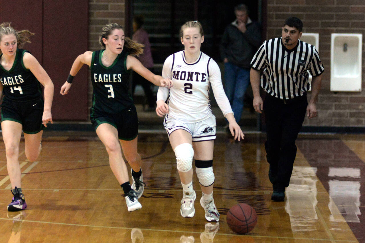 RYAN SPARKS | THE DAILY WORLD Montesano guard Tieander Olson (2) dribbles away from Klahowya’s McKenna Sullivan (3) during the Bulldogs’ 70-27 victory on Wednesday at Montesano High School.
