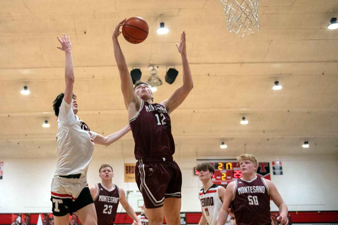 JOSH KIRSHENBAUM | THE CHRONICLE Montesano’s Gabe Bodwell (12) comes down with a rebound during Montesano’s 59-46 loss on Tuesday in Tenino.
