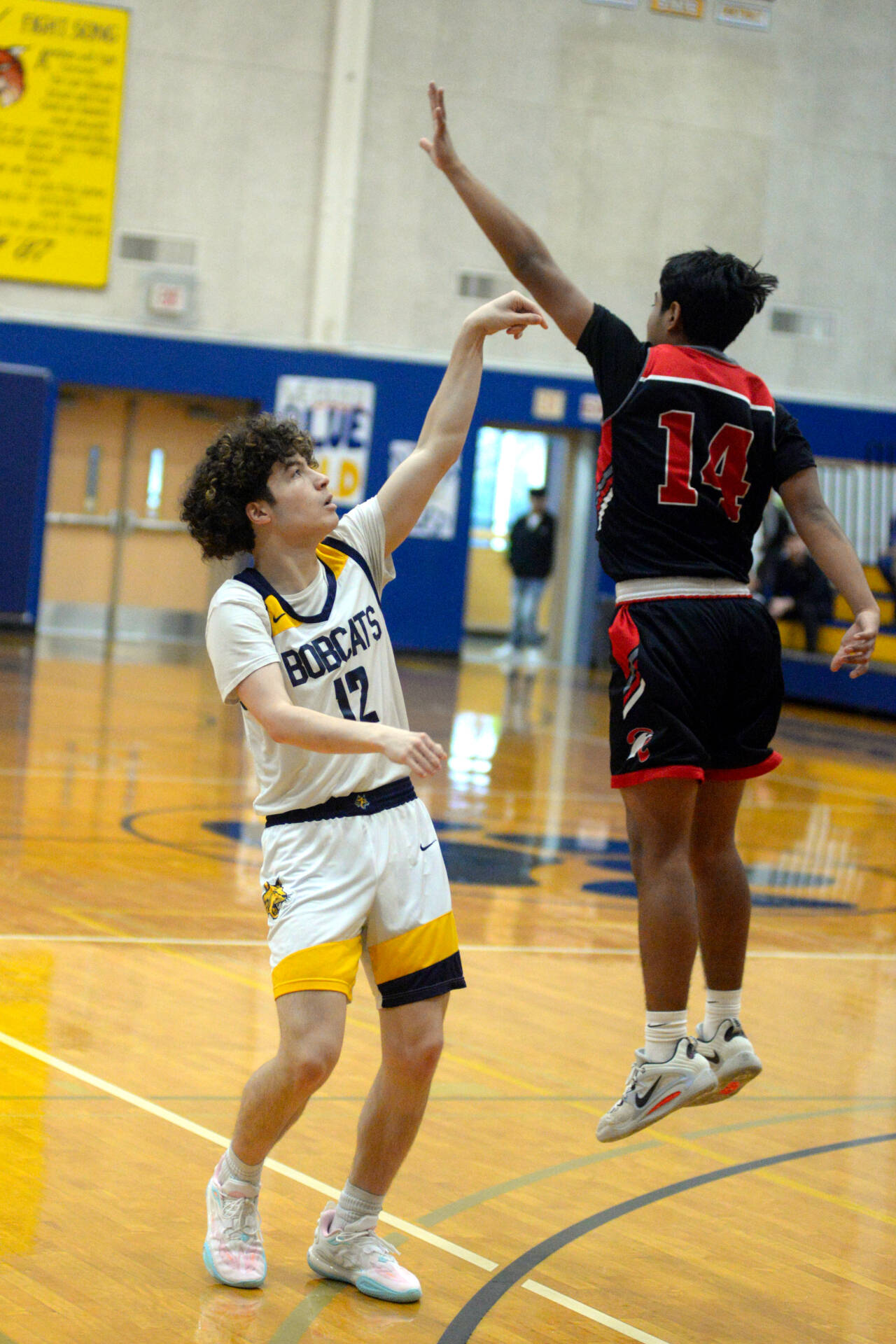 RYAN SPARKS | THE DAILY WORLD Aberdeen’s Manny Garcia (12) shoots a 3-pointer while defended by Raymond’s Chris Quintana during the Bobcats’ 55-54 win on Saturday in Aberdeen.