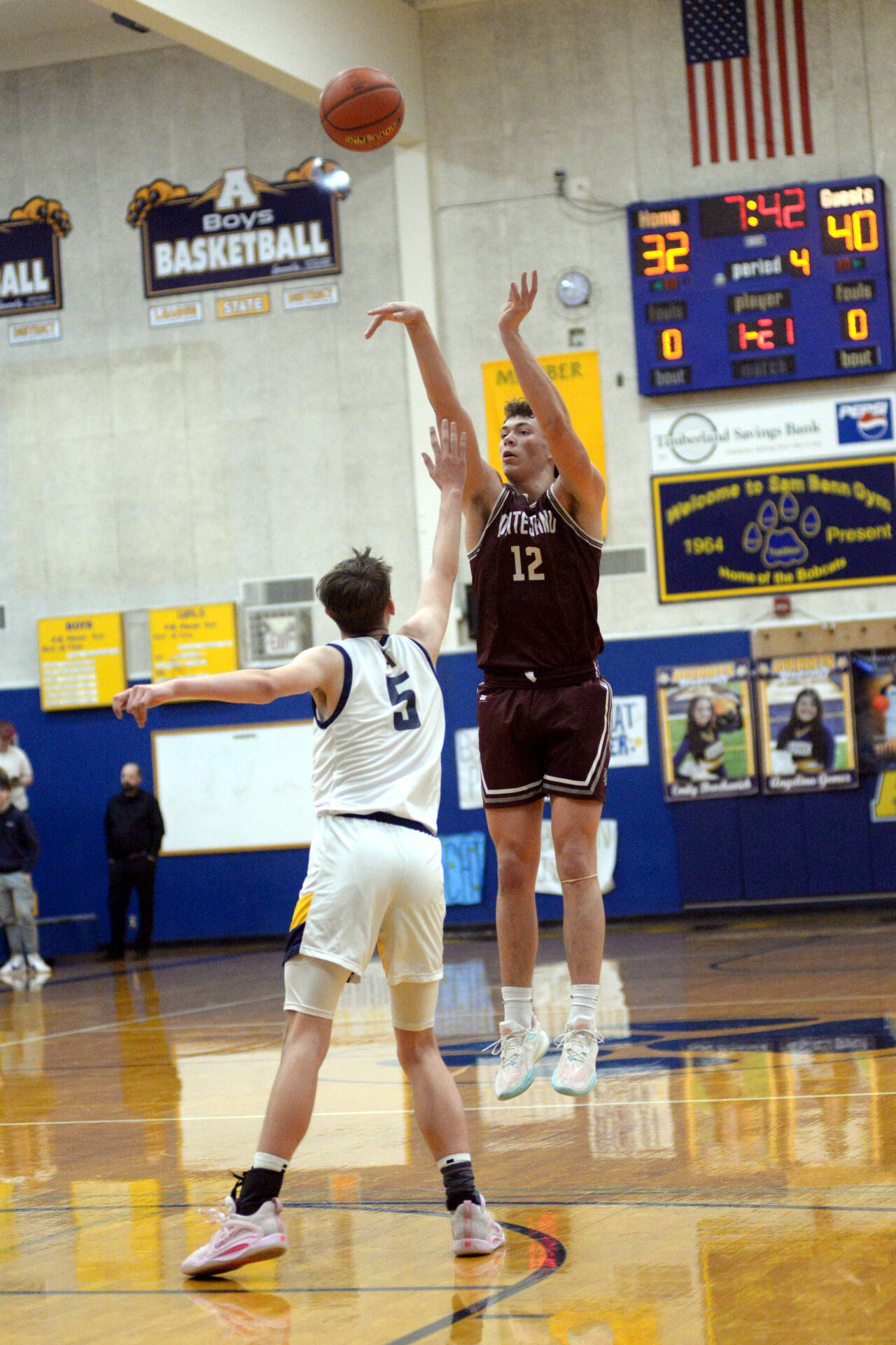 RYAN SPARKS | THE DAILY WORLD Montesano senior Gabe Bodwell (12) shoots while defended by Aberdeen’s Baylor Ainsworth during Monte’s 52-38 victory on Saturday at Aberdeen High School.
