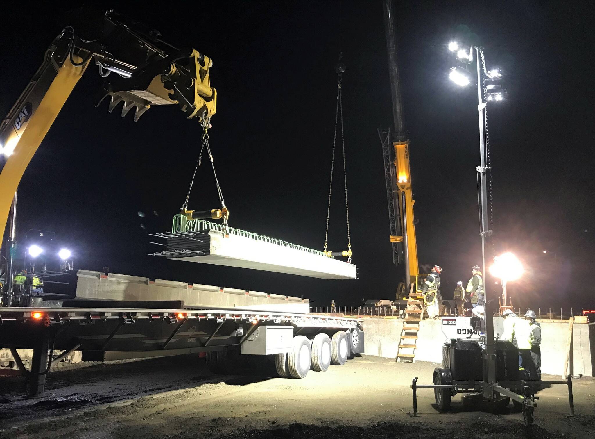 Ceccanti, Inc. crews overnight unload concrete girders onto WSDOT’s fish barrier removal project. (Courtesy photo / WSDOT)