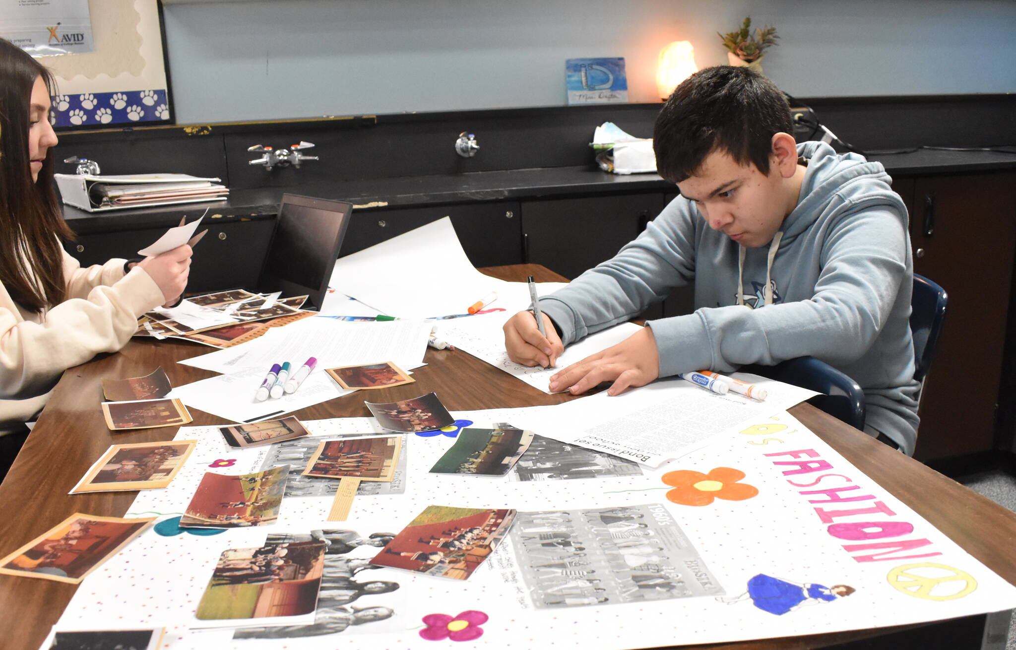 Clayton Franke / The Daily World
Anthony Ceja works on a poster displaying information about the 1960s and 70s on Friday Jan. 19. The poster will be on display during the Miller Junior High School centennial celebration Sunday, Jan. 28 — which also happens to be Ceja’s birthday.