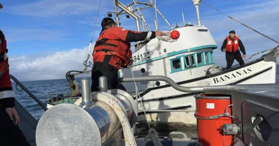 Courtesy photo / USCG
Coast Guardsmen toss a line to a disabled vessel before towing it in to Westport on Tuesday.