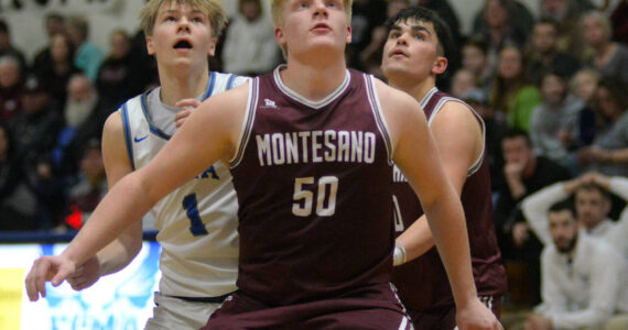 RYAN SPARKS | THE DAILY WORLD Montesano’s Cam Taylor (50) Jaxson Wilson, right, compete for a rebound with Elma’s Isaac McGaffey (1) during Monte’s 69-59 win on Friday in Elma.