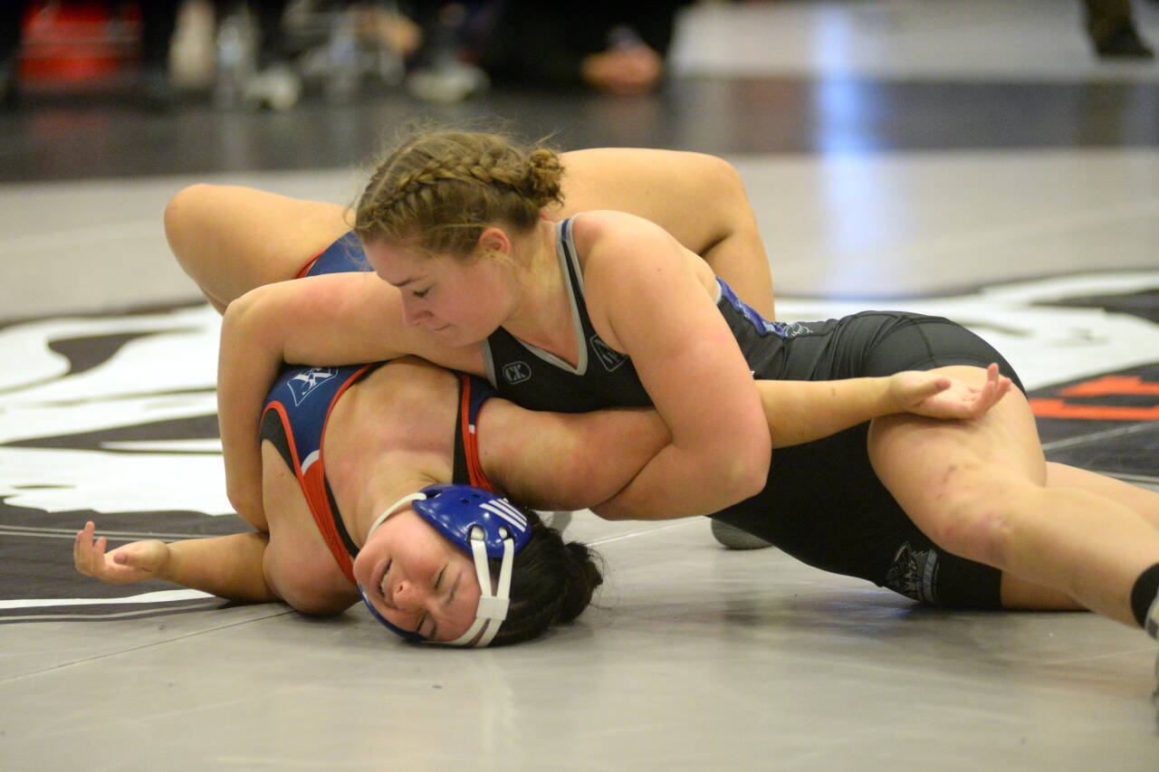RYAN SPARKS | THE DAILY WORLD Grays Harbor College’s Hailee Stoken, top, works to pin Utah Tech’s Ashley Lavarius during a 155-pound match at the NCWA Women’s National Freestyle Invitational on Sunday at Hoquiam High School.