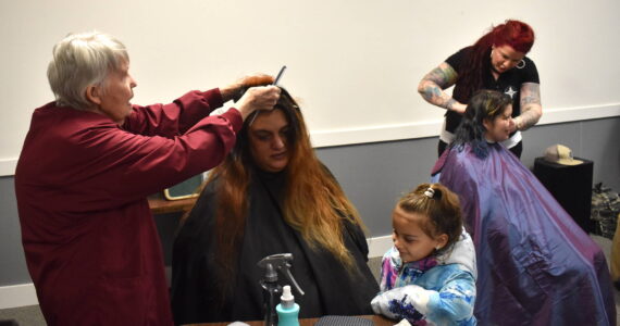 Clayton Franke / The Daily World
Hairdresser Pat Gordon, left, provides a haircut to Alisha Polequin, whose daughter, Millie Polequin, looks on. The haircuts were one service provided at Grays Harbor’s 2024 Point in Time Count at the Aberdeen Senior Center on Thursday, Jan. 25.