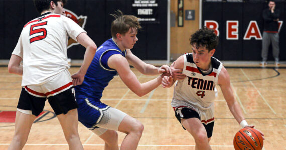 DYLAN WILHELM | THE CHRONICLE
Preston Snider dribbles around a defender during Tenino's win over Elma on Jan. 31.