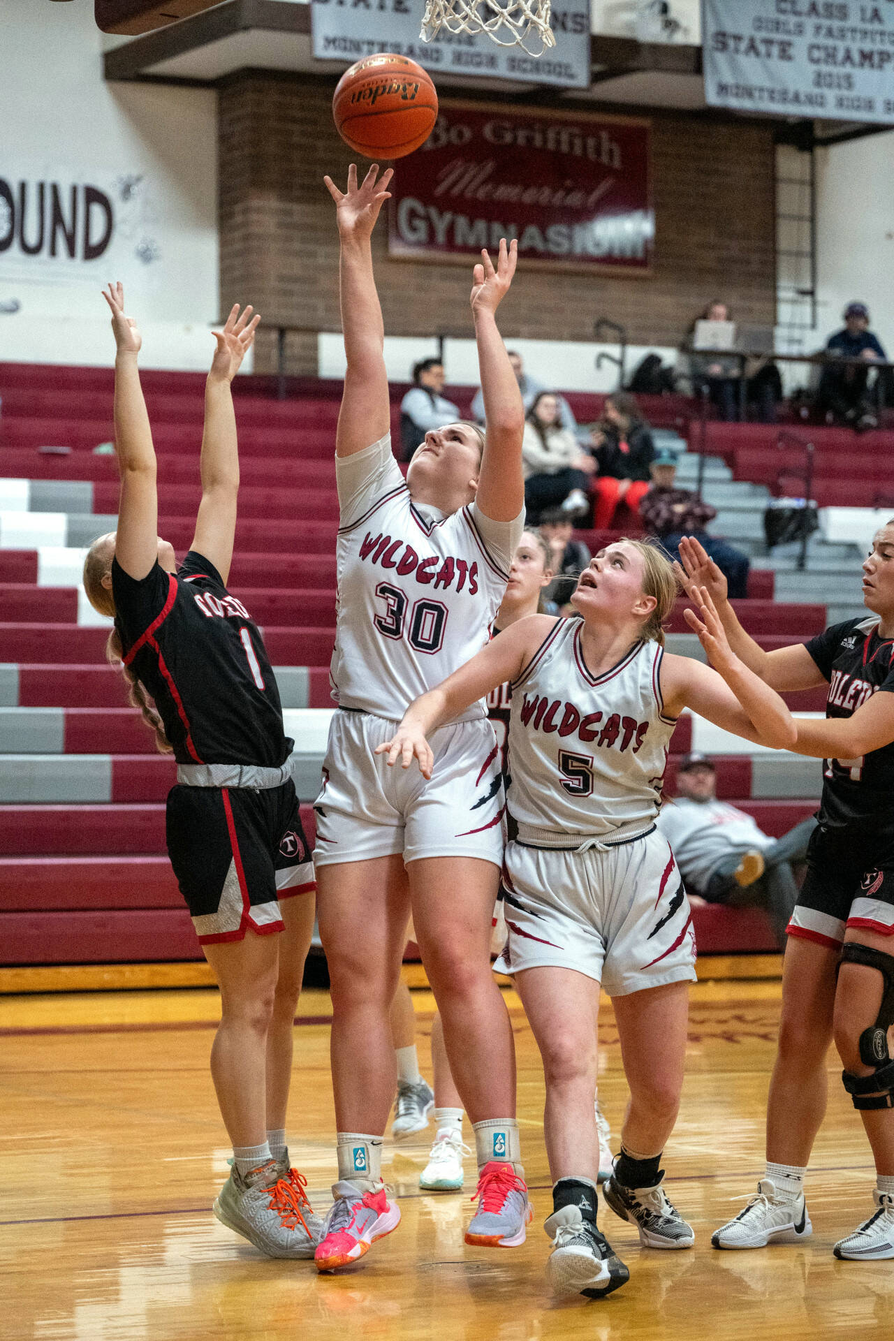 PHOTO BY FOREST WORGUM Ocosta center Alexia Bradley (30) puts up a shot while teammate Anna Davis (5) looks on during a 69-37 loss to Toledo in the first round of the 2B District 4 Tournament on Saturday in Montesano. Toledo’s Kailea Lairson (1) defends on the play.