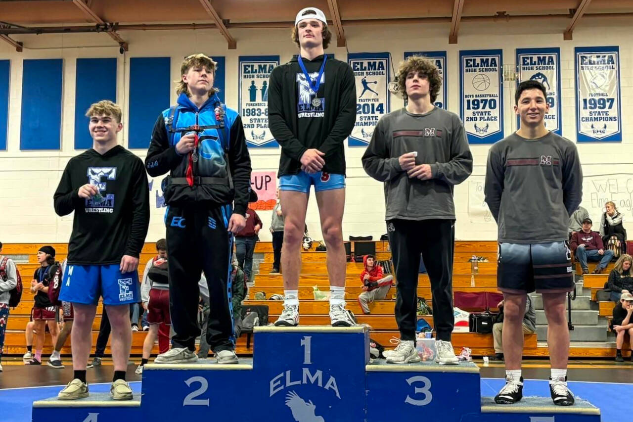 SUBMITTED PHOTO Elma’s Eastin Wright (1) stands atop the podium after winning the 165-pound weight class at the 1A Evergreen Sub-Regionals on Saturday at Elma High School.