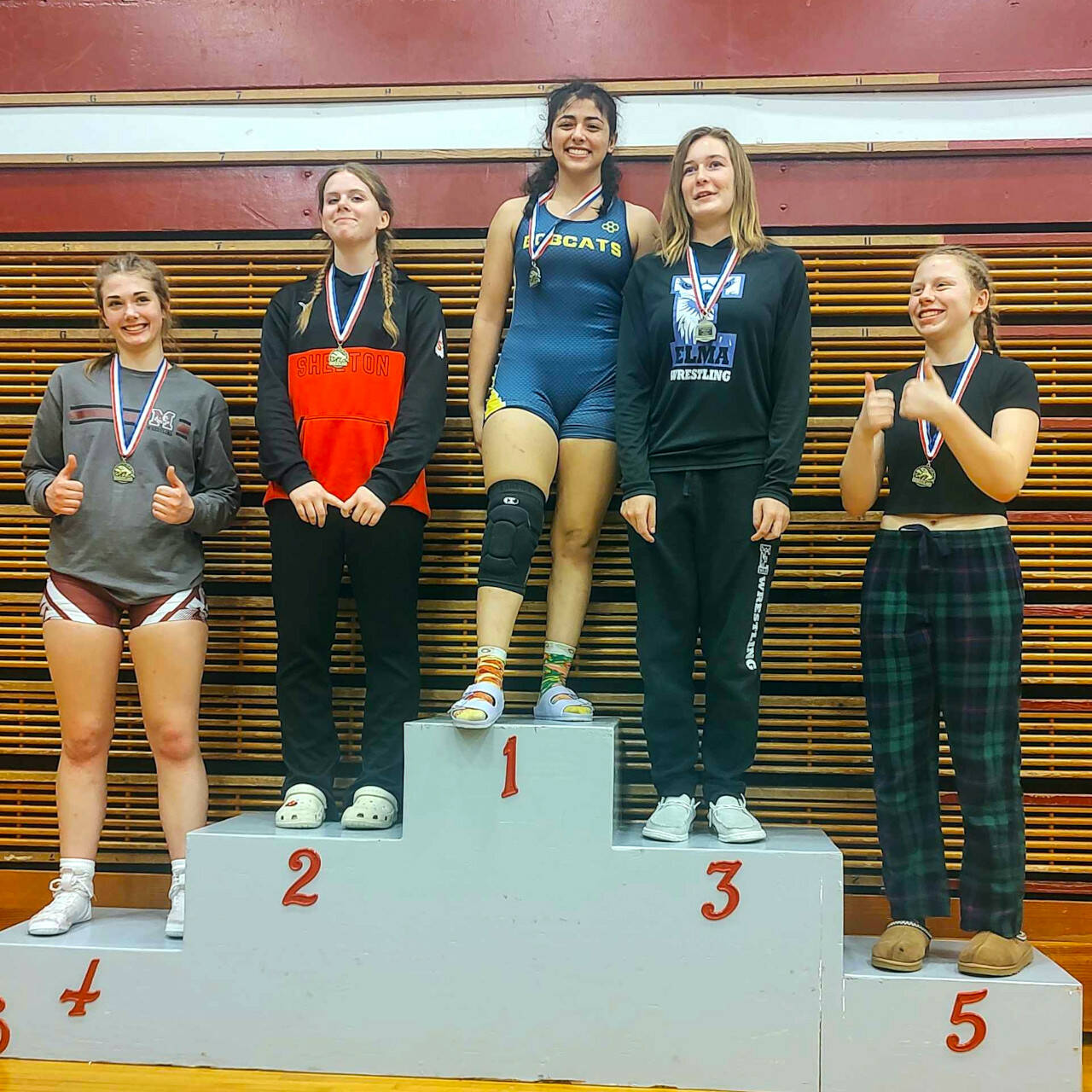 SUBMITTED PHOTO Aberdeen’s Peityn Munoz stands atop the podium after winning the 140-pound weight class at the WIAA District 4 Girls North 1B/2B/1A/2A Sub-Regional meet on Saturday at Hoquiam High School. Elma’s Taylor Nesmith (3) and Montesano’s Emma Peterson (4) are also pictured.