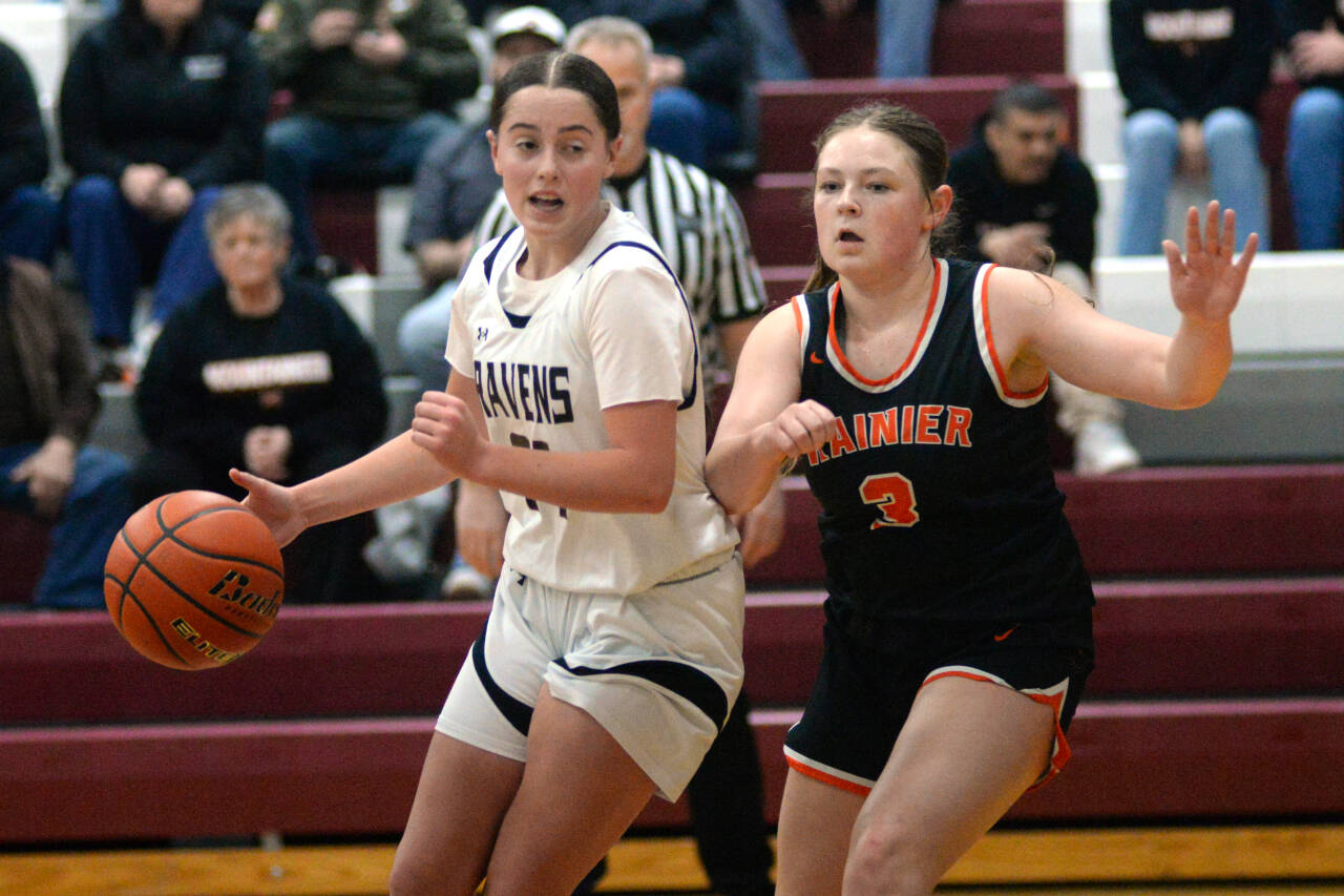 RYAN SPARKS | THE DAILY WORLD Raymond-South Bend’s Avalynn Stigall, left, dribbles against Rainier’s Brooklynn Swenson during the Ravens’ 70-48 loss in the 2B District 4 Tournament on Tuesday in Montesano.