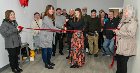 Kimberly Stoll-French / CCAP
Kimberly Stoll-French, center-right, and Cassie Lentz, center-left, cut a ribbon on Feb. 5 to signal to opening of a new 10-bed transitional housing project in Hoquiam that will host youth ages 18-24.