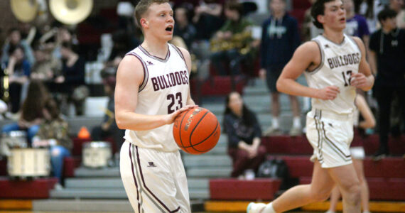 RYAN SPARKS | THE DAILY WORLD Montesano’s Tyce Peterson (23) calls out a play while flanked by teammate Gabe Bodwell during the Bulldogs’ 75-58 victory over Stevenson in a 1A District 4 Tournament game on Wednesday in Montesano.