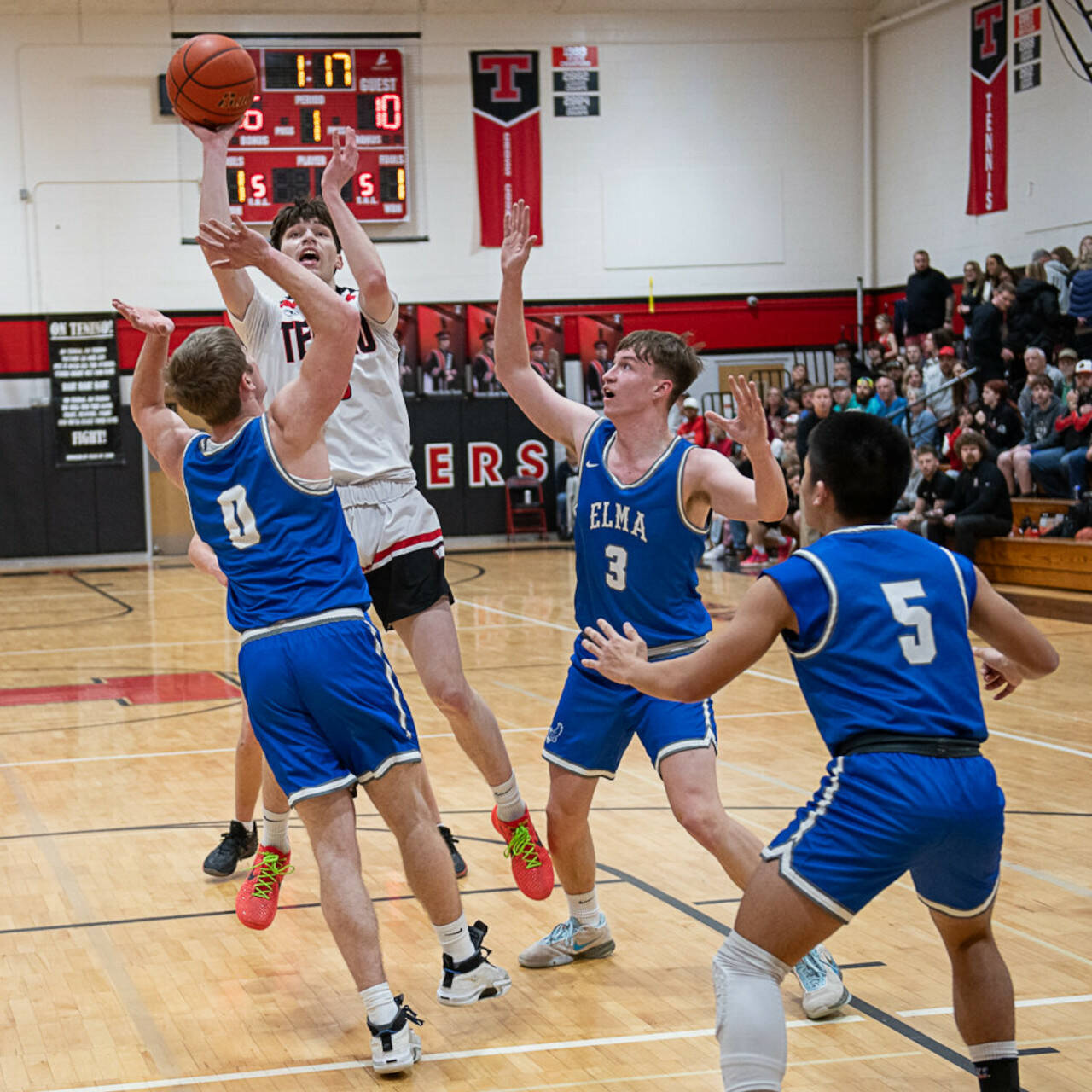 KODY CHRISTEN | THE CHRONICLE Elma’s Traden Carter (0), AJ Holmes (3) and Theo Flores (5) defend Tenino’s Noah Schow during the Eagles’ 63-52 loss in a 1A District 4 semifinal game on Friday in Tenino.