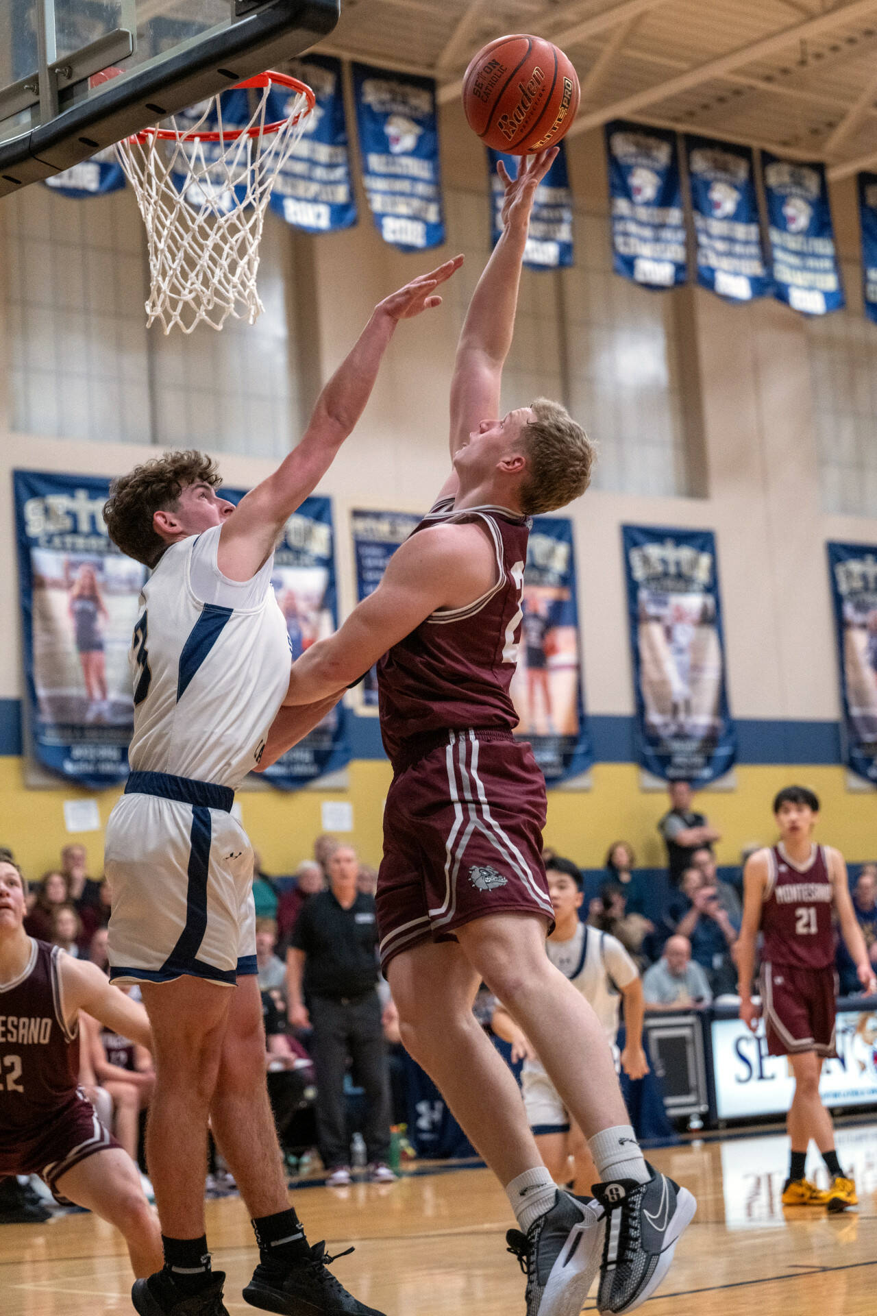 PHOTO BY FOREST WORGUM Montesano senior Tyce Peterson, right, drives to the hoop during the Bulldogs’ 58-46 loss to Seton Catholic in a 1A District 4 Tournament semifinal game on Friday in Vancouver.
