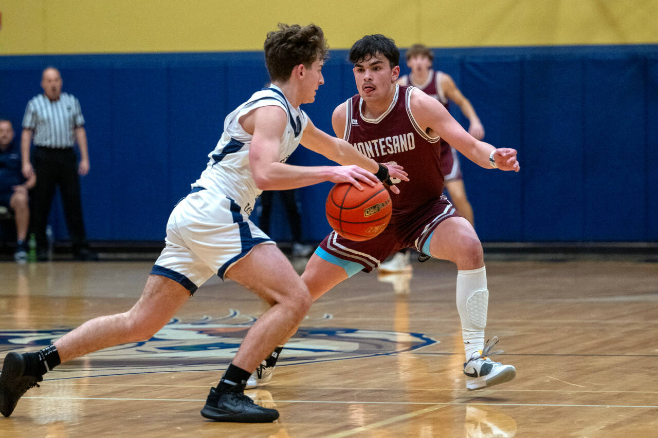 PHOTO BY FOREST WORGUM Montesano senior Jaxson Wilson, right, defends a Seton Catholic player during the Bulldogs’ 58-46 loss in a 1A District 4 Tournament semifinal game on Friday in Vancouver.