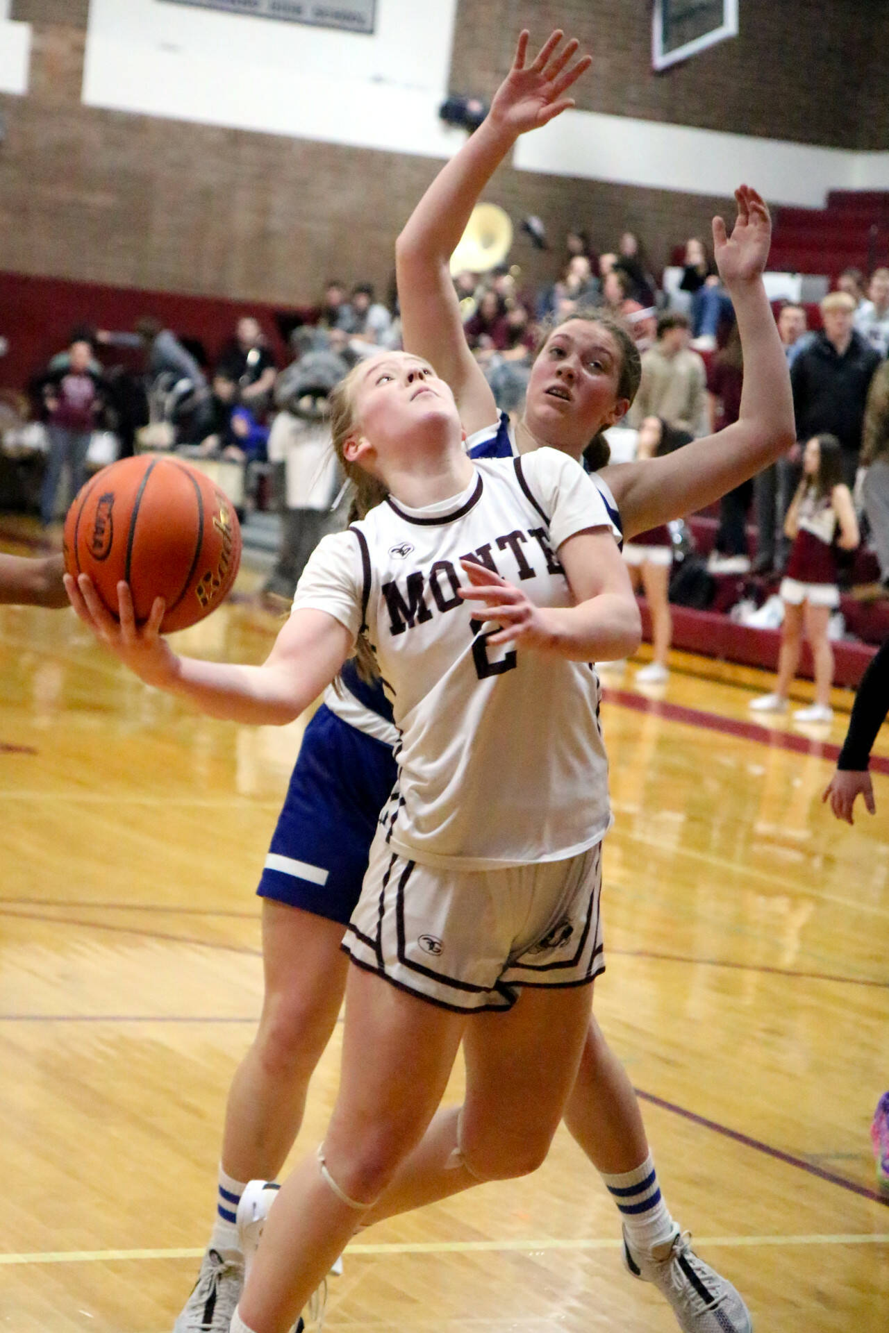 RYAN SPARKS / THE DAILY WORLD Montesano’s Tieander Olson (2) drives the lane against Elma’s Olivia Moore during the Bulldogs’ 37-22 win in a 1A District 4 semifinal game on Saturday in Montesano.