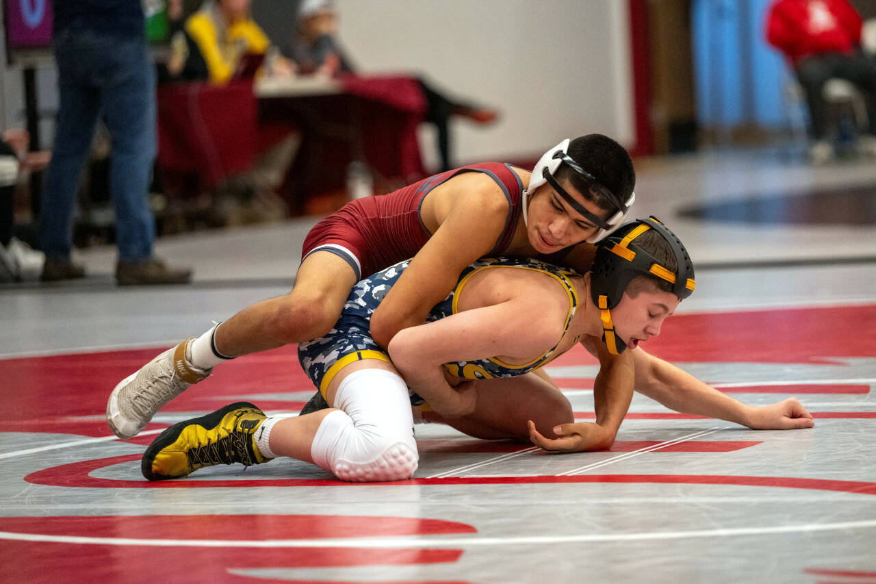 PHOTO BY FOREST WORGUM Hoquiam’s Junior Soto, top, wrestles against Seton Catholic’s Connor Crum during a 120-pound semifinal match at the WIAA Region 2 Tournament on Saturday at Hoquiam High School.