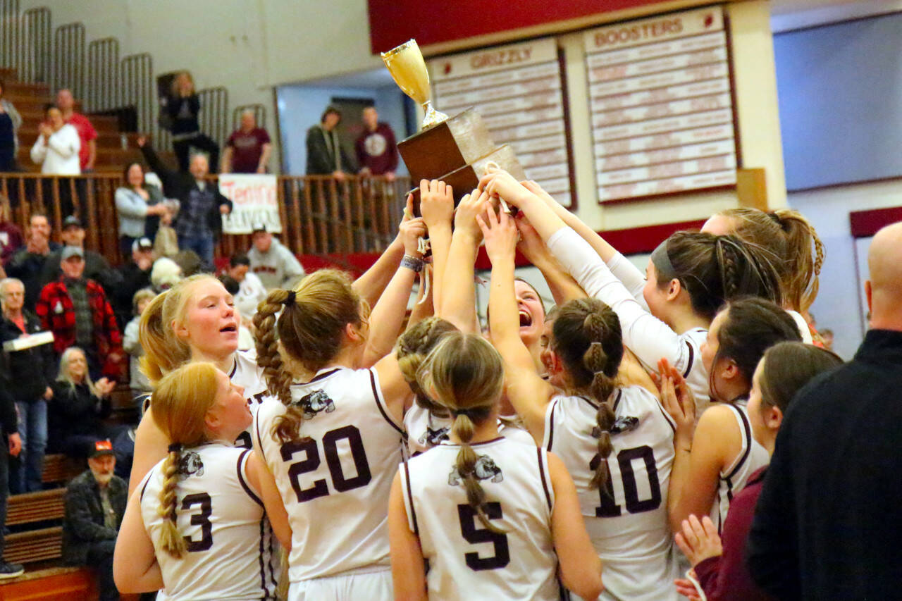 RYAN SPARKS | THE DAILY WORLD The Montesano Bulldogs hoist the 1A District 4 championship trophy after defeating Seton Catholic 41-36 on Saturday at Hoquiam High School.