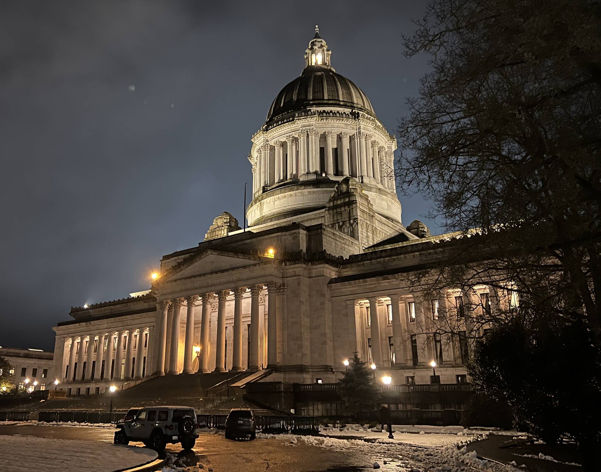 The Washington State Legislative Building in Olympia is illuminated the evening of Thursday, Feb. 15, the day the Senate released its proposed supplemental capital budget. (Clayton Franke / The Daily World)