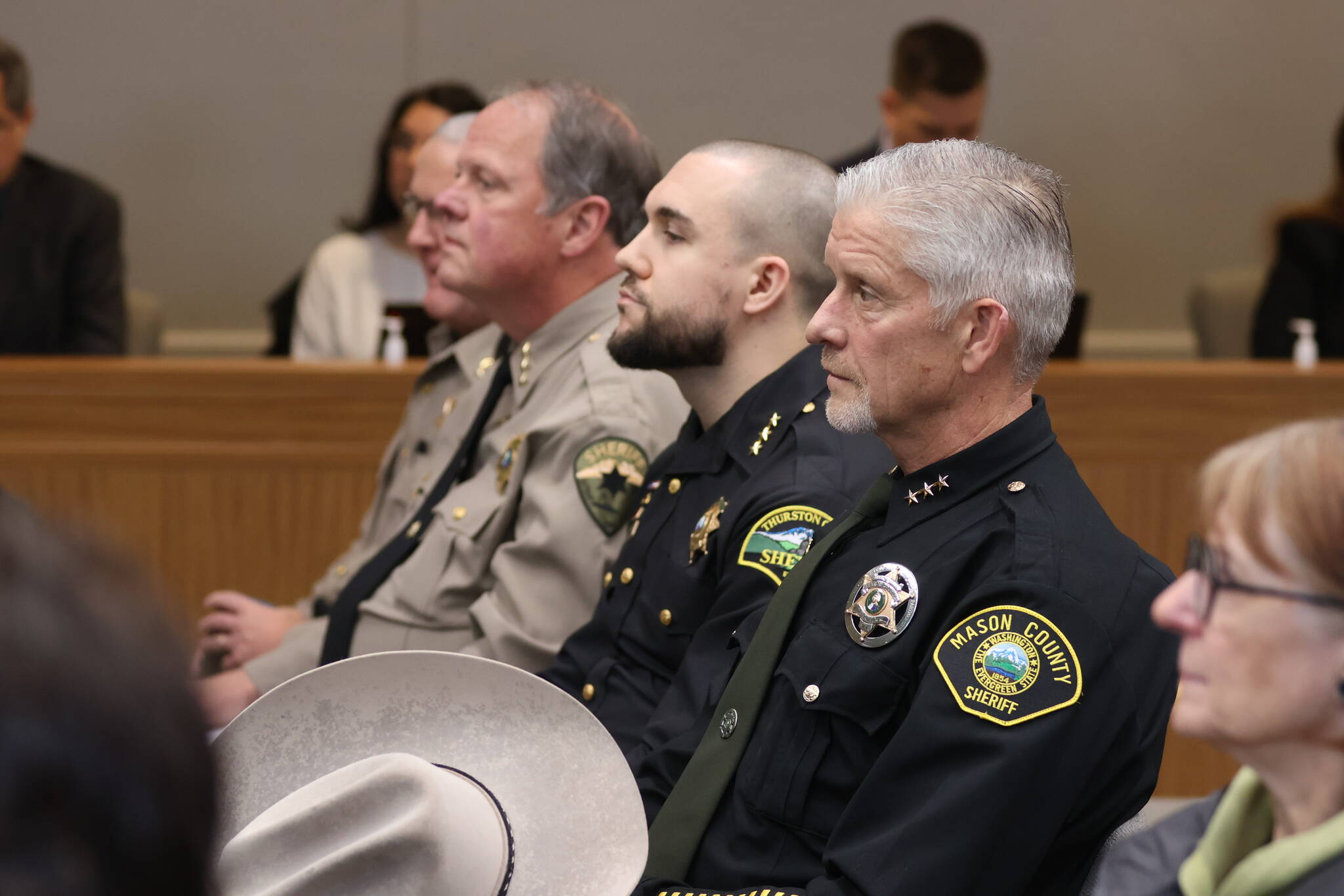 Sheriffs and police chiefs watch during a public hearing on a police pursuit initiative in Olympia on Wednesday. (Michael S. Lockett / The Daily World)