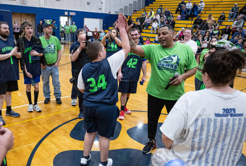 <p>Mary White</p>
                                <p>Gerald Smiley, former Texas Rangers pitcher, high-fives Kyler Parmley at the 2023 Grays Harbor Hawks celebrity basketball game.</p>