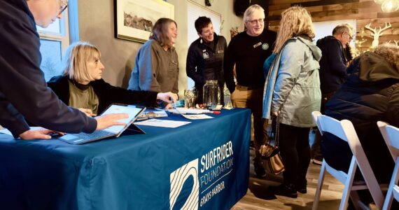 Kimberly Johnson / Surfrider Grays Harbor
Local chapter chair Bruce Rittenhouse and state coordinator Liz Schotman, center, converse with an attendee at a launch party for the Surfrider Foundation’s new Grays Harbor chapter at the Oyhut Bay Grill in Ocean Shores on Feb. 27.