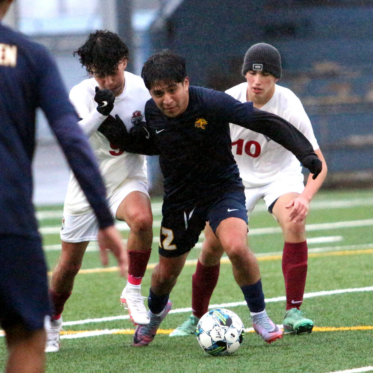 RYAN SPARKS | THE DAILY WORLD Aberdeen senior Chris Garcia, middle, holds off two Hoquiam defenders during the Bobcats’ 5-0 victory on Monday in Aberdeen.