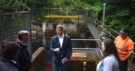 The Daily World file photo
U.S. Rep. Derek Kilmer talks with Hoquiam City Administrator Brian Shay during a July 24, 2024 visit to the West Fork Hoquiam Dam. A recent congressional spending bill includes $500,000 for the city’s dam removal and water supply project.