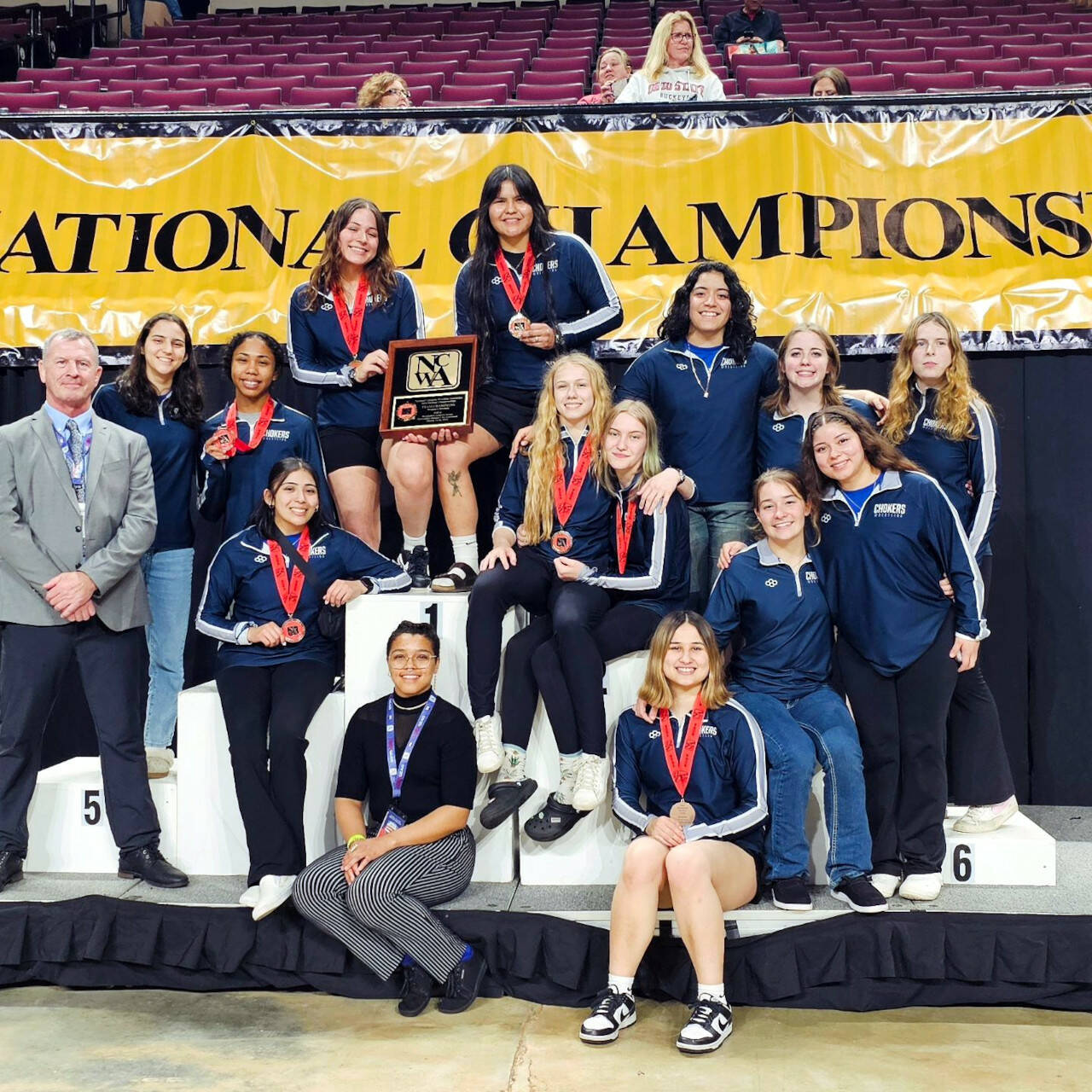 SUBMITTED PHOTO Led by national champions Renaeh Ureste (top left) and JoJera Dodge (top right), the Grays Harbor College women’s wrestling team won the NCWA National Championship on Saturday in Bossier City, Louisiana. Head coach Kevin Pine (far left) was named National Women’s Coach of the Year.