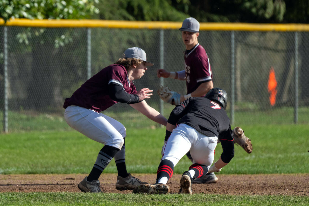 PHOTO BY FOREST WORGUM Montesano pitcher Skylar Bove attempts to tag out Tenino’s Austin Gonia (7) during the Bulldogs’ 10-6 loss on Tuesday at Vessey Field in Montesano.