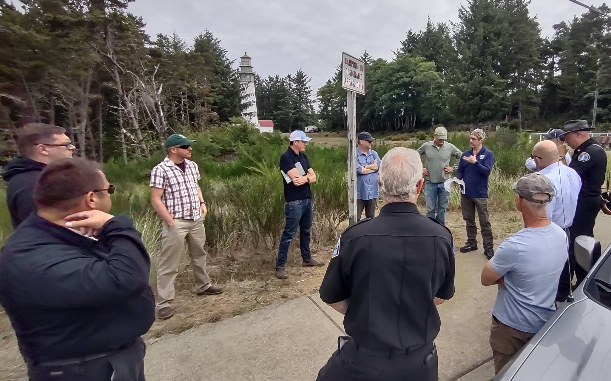 Marc Titus, a community wildfire resilience specialist with the Department of Natural Resources, talks with a group of local leaders and fire officials about wildfire risk in Westport at the Grays Harbor Lighthouse on Aug. 10, 2023. (John Shaw)