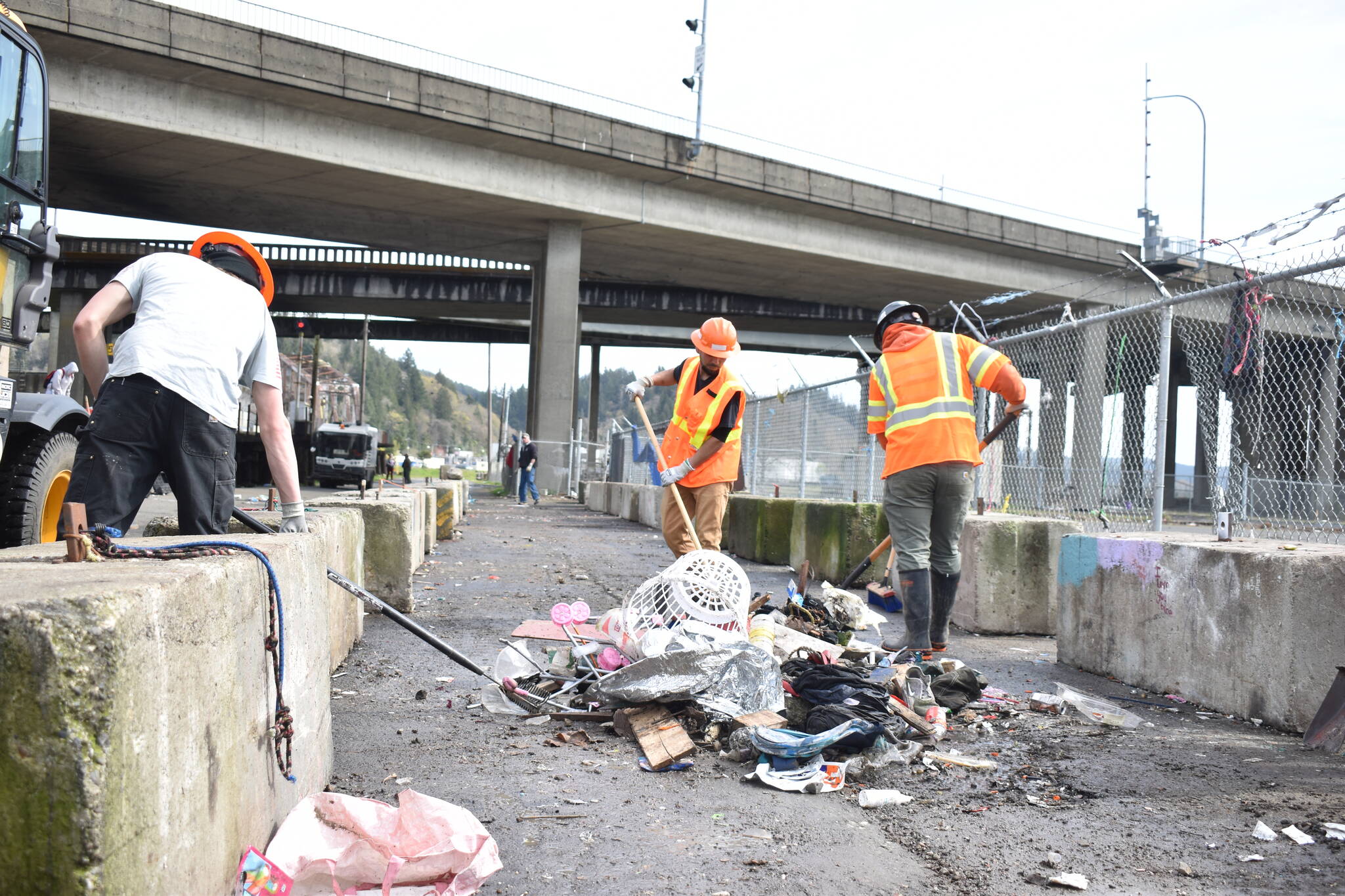 Clayton Franke / The Daily World
City of Aberdeen workers sweep the last of the debris from a River Street homeless camp cleanup April 3. The city will perform intensive cleanups there once per month moving forward.