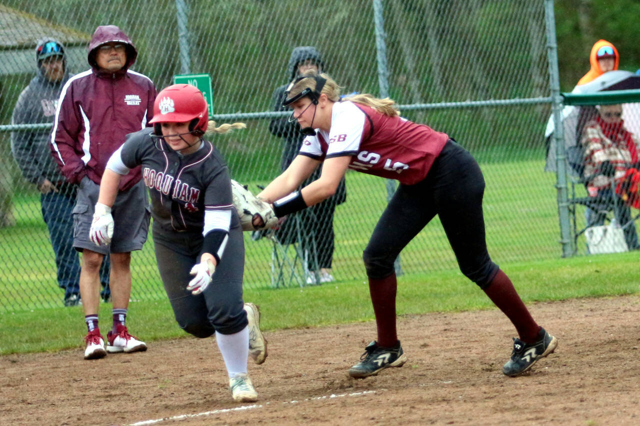 RYAN SPARKS | THE DAILY WORLD Raymond-South Bend third baseman Kassie Koski, right, tags out Hoquiam’s Macy Dhooghe trying to score during the Ravens’ 15-7 win on Thursday at John Gable Park in Hoquiam.