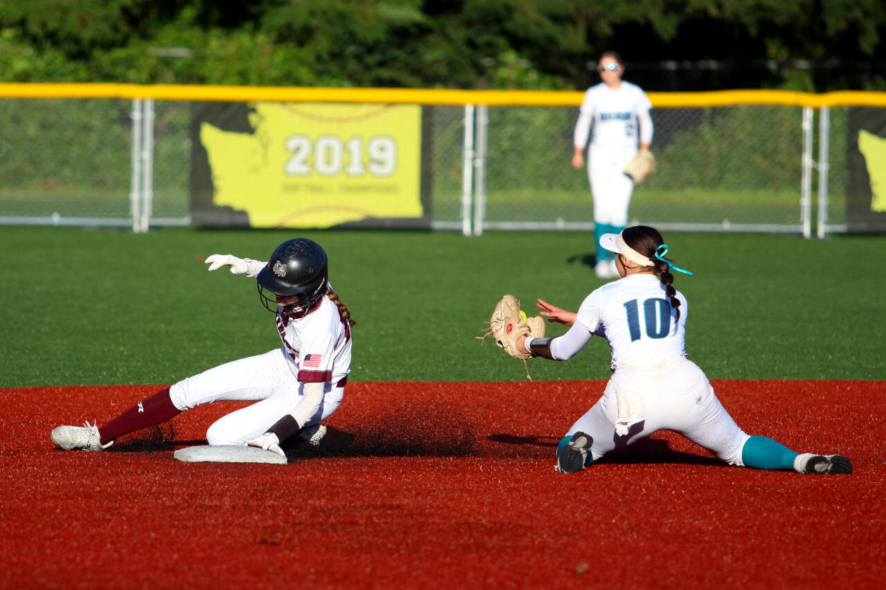 RYAN SPARKS | THE DAILY WORLD Montesano’s Lex Stanfield, left, slides in safely at second base ahead of the tag of Auburn Riverside’s Bailee Brader during the Bulldogs’ 7-1 loss on Tuesday in Montesano.