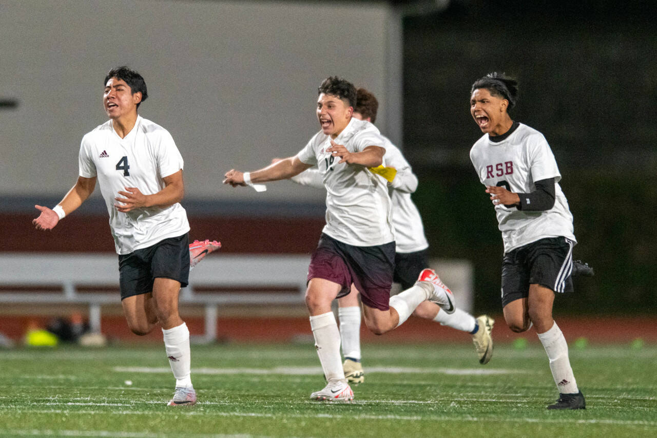 PHOTO BY FOREST WORGUM Raymond-South Bend’s Christopher Quintana (4), Michael Nunez (middle) and Adam Mora celebrate a 3-2 win (4-2 on penalty kicks) over Montesano on Friday at Montesano High School