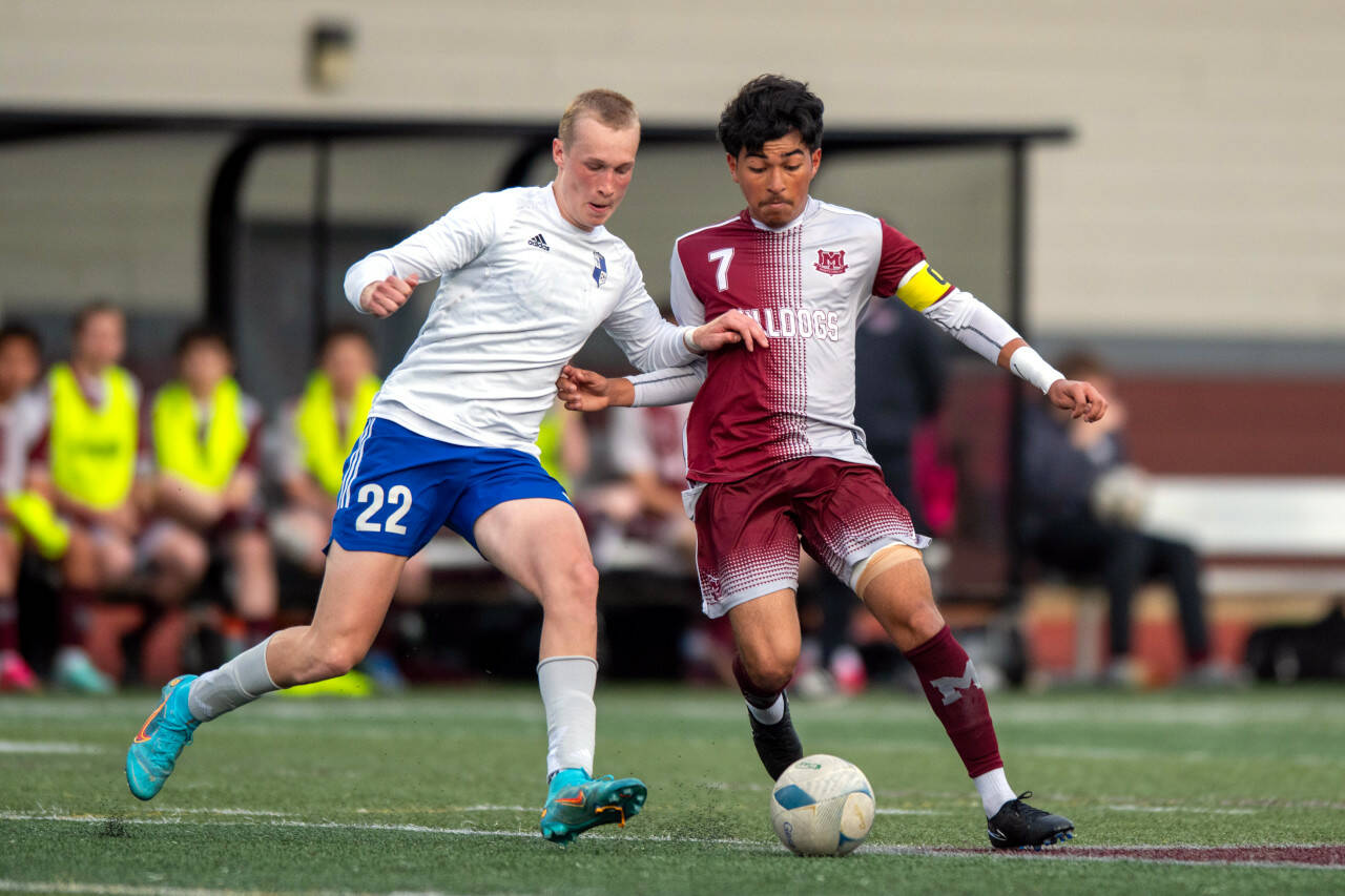 PHOTO BY FOREST WORGUM 
Elma’s Cason Seaberg (22) and Montesano’s Cris Tobar jostle for possession during the Bulldogs’ 1-0 win on Monday at Jack Rottle Field in Montesano.