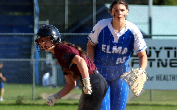RYAN SPARKS | THE DAILY WORLD Montesano’s Carsyn Wintrip, left, leads off first while Elma first baseman Callie Galligan looks toward home plate during the Bulldogs’ 8-7 win on Monday in Elma.
