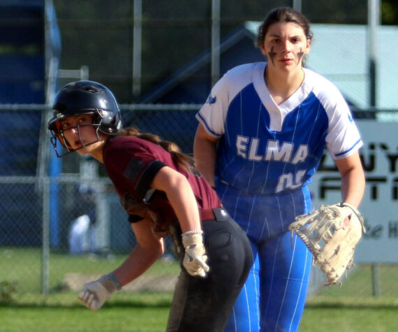 <p>RYAN SPARKS | THE DAILY WORLD Montesano’s Carsyn Wintrip, left, leads off first while Elma first baseman Callie Galligan looks toward home plate during the Bulldogs’ 8-7 win on Monday in Elma.</p>