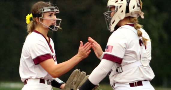 RYAN SPARKS | THE DAILY WORLD Montesano pitcher Riley Timmons, left, and catcher Ali Parkin prepare for the start of an inning during the Bulldogs’ 7-0 win on Wednesday in Montesano.