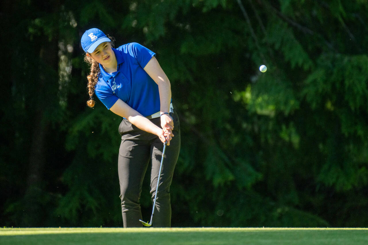 PHOTO BY FOREST WORGUM Elma Olivia Moore chips during a 195-195 tie against Montesano on Thursday at the Grays Harbor Country Club in Aberdeen.